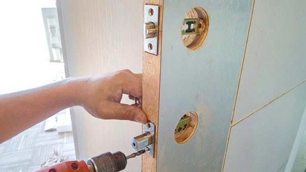 locksmith fitting a locking mechanism